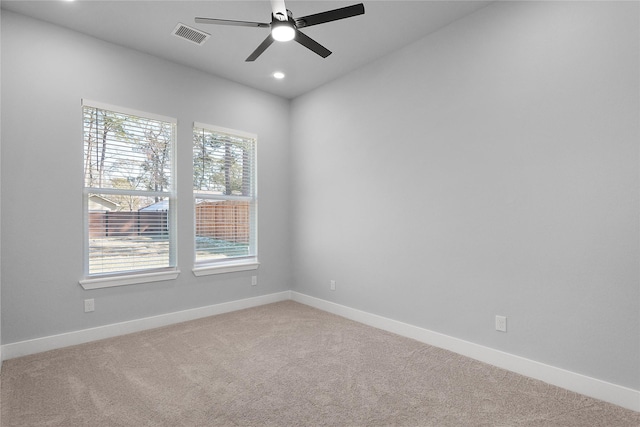 carpeted spare room featuring recessed lighting, visible vents, ceiling fan, and baseboards