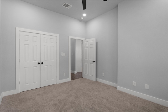 unfurnished bedroom with carpet floors, a closet, visible vents, a ceiling fan, and baseboards