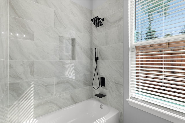 bathroom featuring a wealth of natural light and shower / bathing tub combination