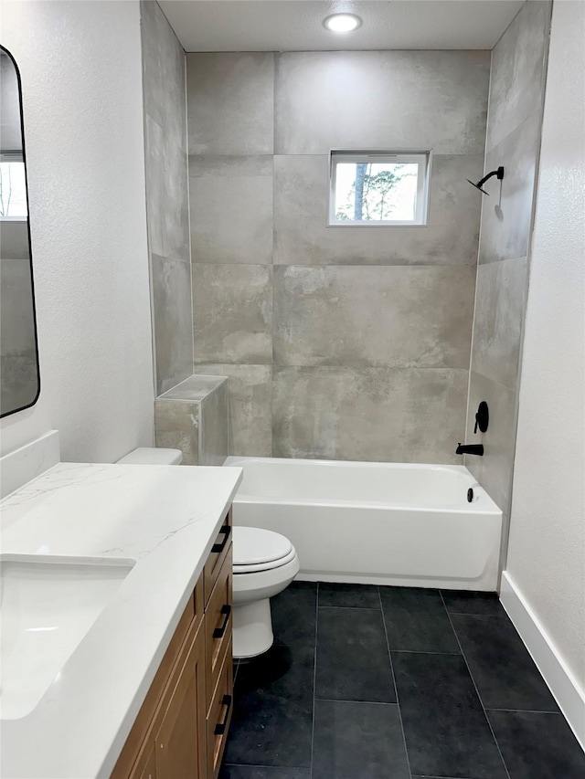 bathroom featuring baseboards, toilet, shower / tub combination, tile patterned flooring, and vanity