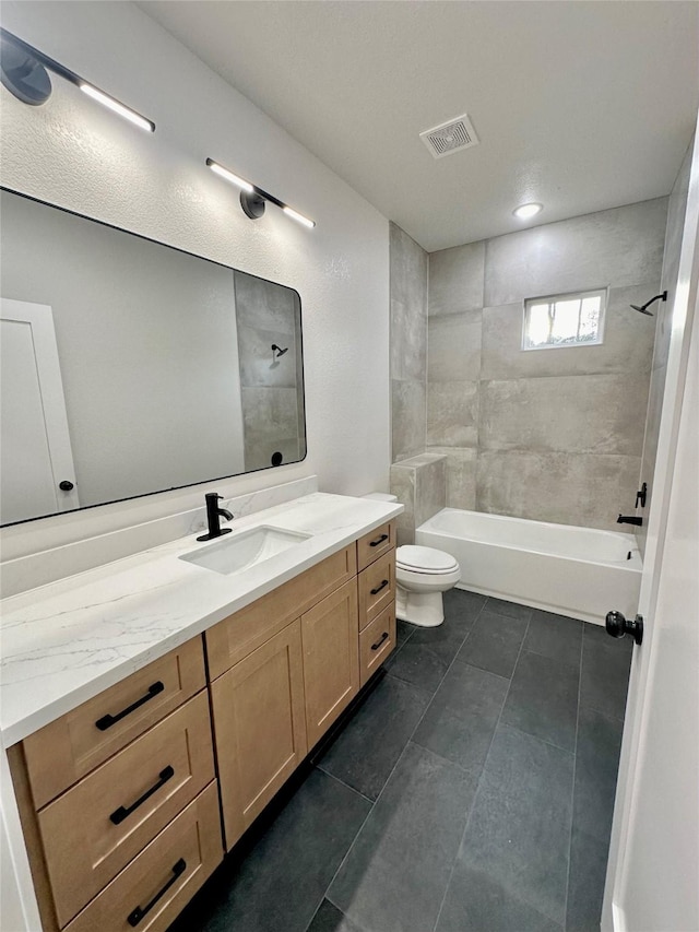 bathroom featuring bathtub / shower combination, visible vents, toilet, vanity, and tile patterned floors