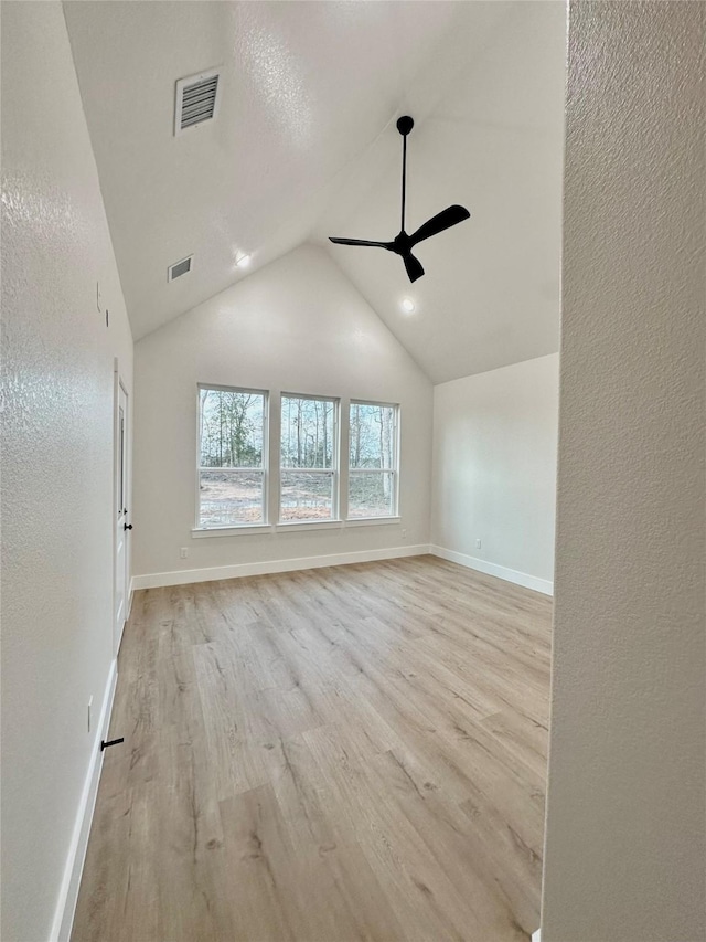 spare room with light wood-style floors, baseboards, visible vents, and a ceiling fan