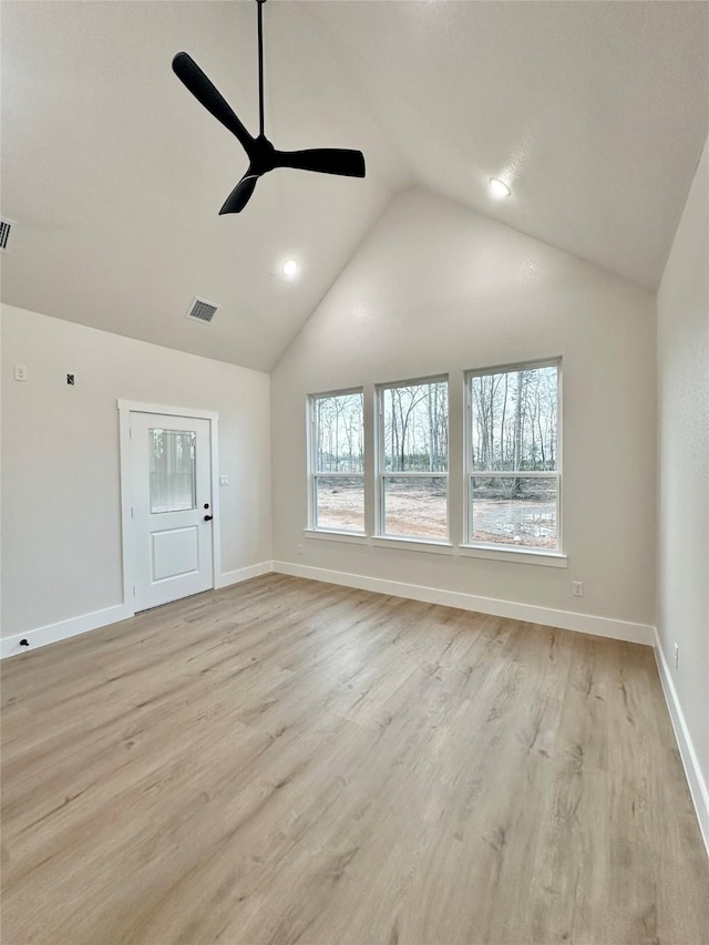 unfurnished room featuring high vaulted ceiling, a ceiling fan, baseboards, visible vents, and light wood-style floors