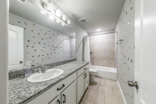 bathroom featuring toilet, tile patterned floors, vanity, visible vents, and shower / tub combo with curtain