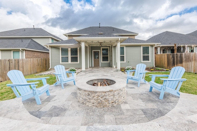 view of patio with an outdoor fire pit and fence