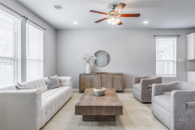 living room with recessed lighting, visible vents, ceiling fan, and baseboards