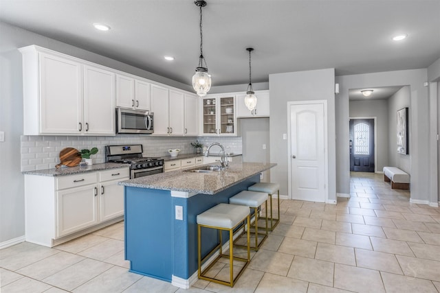 kitchen featuring white cabinetry, appliances with stainless steel finishes, and a sink