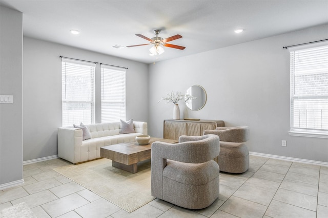 living area with plenty of natural light, visible vents, baseboards, and light tile patterned flooring