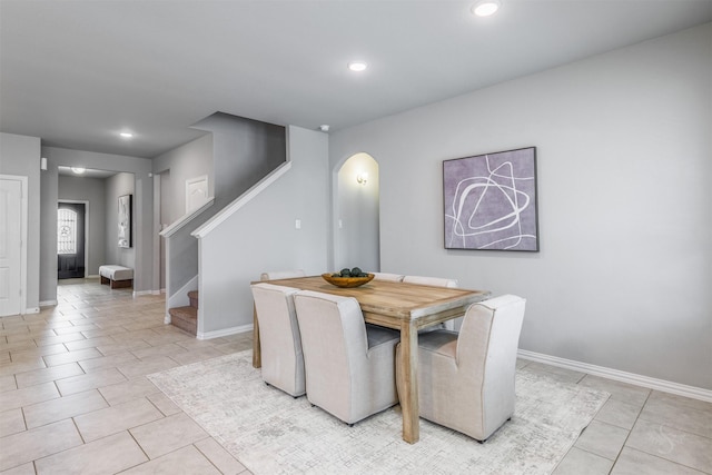 dining room featuring recessed lighting, stairs, baseboards, and light tile patterned flooring