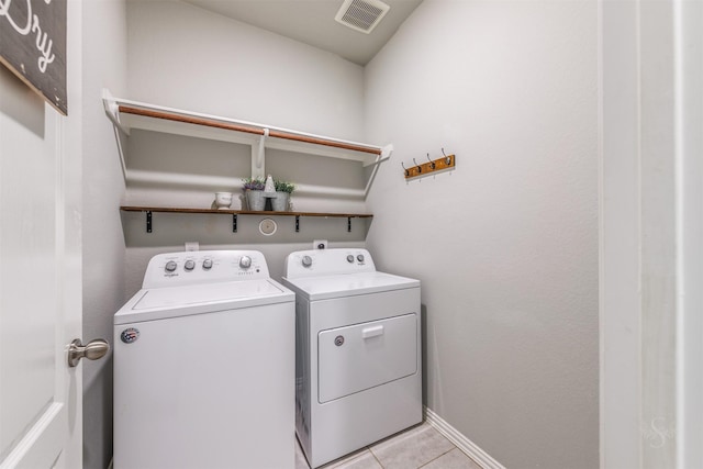 laundry room with laundry area, baseboards, visible vents, washer and clothes dryer, and light tile patterned flooring