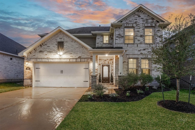 view of front of house with a garage, brick siding, a shingled roof, driveway, and a lawn