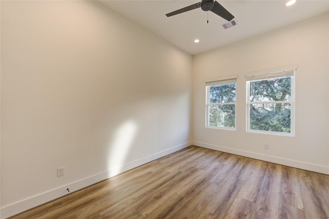 unfurnished room with baseboards, visible vents, a ceiling fan, light wood-style floors, and recessed lighting