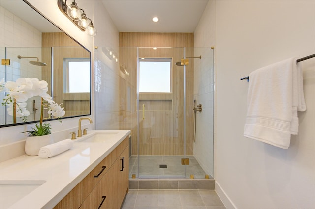 full bathroom featuring double vanity, recessed lighting, a stall shower, a sink, and tile patterned flooring