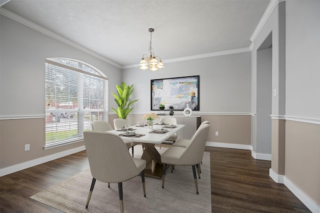 dining area with a chandelier, a textured ceiling, wood finished floors, and a healthy amount of sunlight