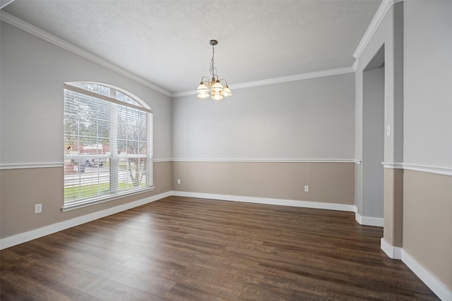 unfurnished room with baseboards, ornamental molding, dark wood-type flooring, a textured ceiling, and a notable chandelier