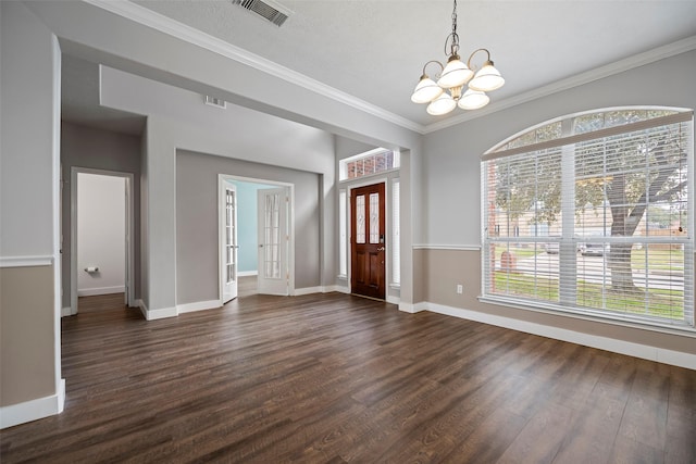 foyer featuring a notable chandelier, dark wood-style flooring, visible vents, baseboards, and plenty of natural light