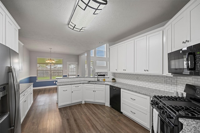 kitchen featuring black appliances, dark wood-style flooring, a sink, and white cabinets