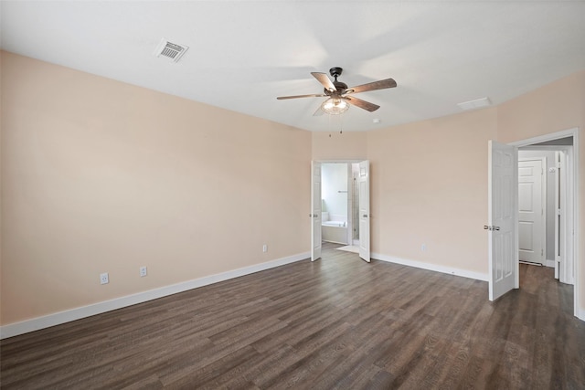 unfurnished bedroom with dark wood-style flooring, visible vents, and baseboards