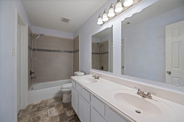 bathroom with visible vents, a sink, toilet, and shower / bathtub combination