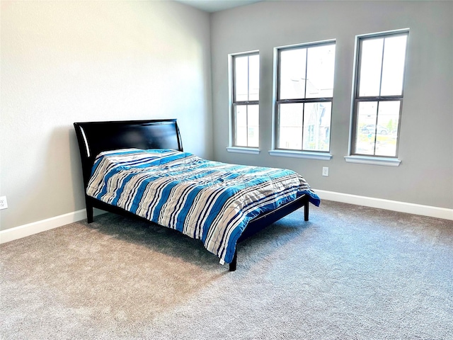 bedroom featuring baseboards and carpet floors