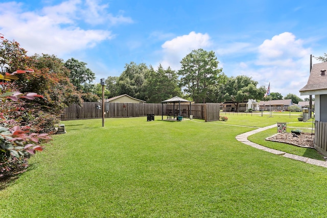 view of yard featuring fence and a gazebo