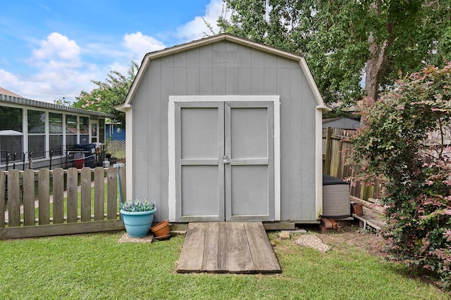 view of shed featuring fence