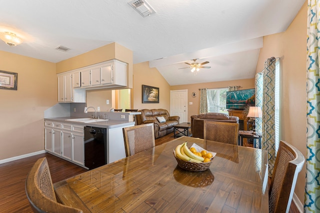 dining area with vaulted ceiling, dark wood-type flooring, visible vents, and baseboards