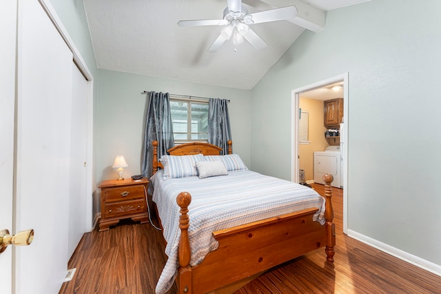 bedroom with a closet, lofted ceiling with beams, wood finished floors, washer / dryer, and baseboards