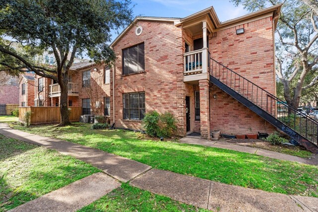2255 Braeswood Park Dr Unit 265, Houston, TX 77030 - view of building exterior featuring stairs and central AC