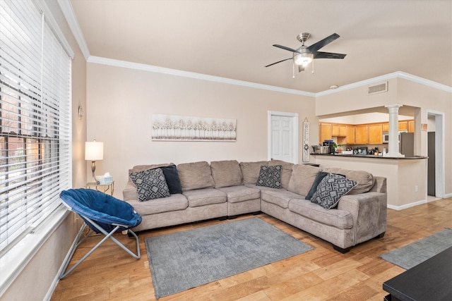 2255 Braeswood Park Dr Unit 265, Houston, TX 77030 - living room with ornate columns, a ceiling fan, ornamental molding, baseboards, and light wood-style floors