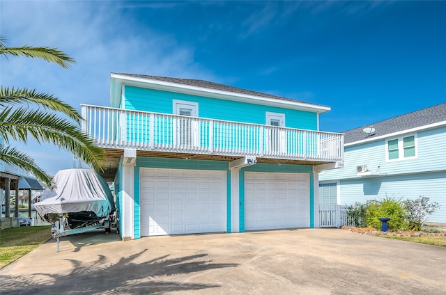 view of front of home with a garage, a balcony, and concrete driveway