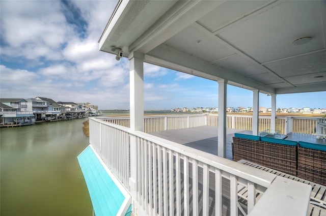 exterior space featuring a deck with water view