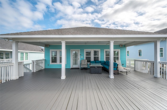 wooden deck with an outdoor living space