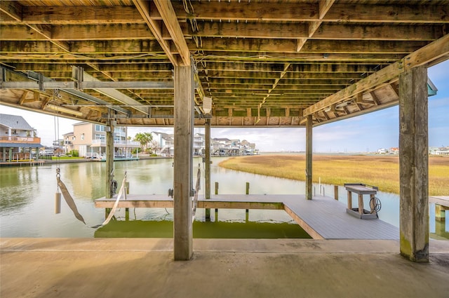 dock area with a water view and boat lift