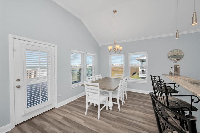 dining area with a chandelier, wood finished floors, a wealth of natural light, and baseboards