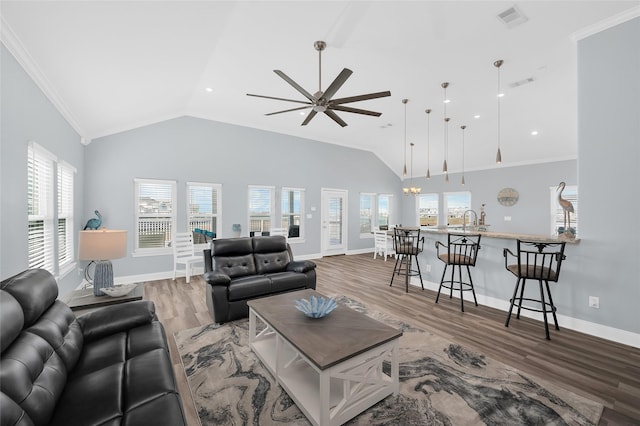 living room featuring visible vents, crown molding, and wood finished floors