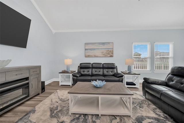 living area with crown molding, wood finished floors, and baseboards