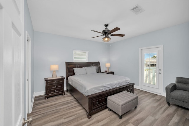 bedroom featuring light wood-type flooring, access to exterior, baseboards, and visible vents