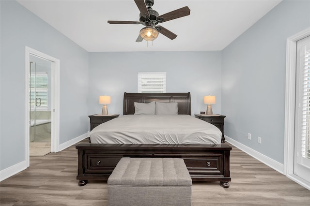 bedroom with light wood-style floors, connected bathroom, baseboards, and ceiling fan