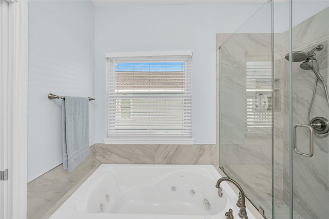 bathroom featuring a jetted tub and a stall shower