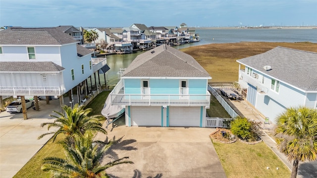 birds eye view of property featuring a water view and a residential view