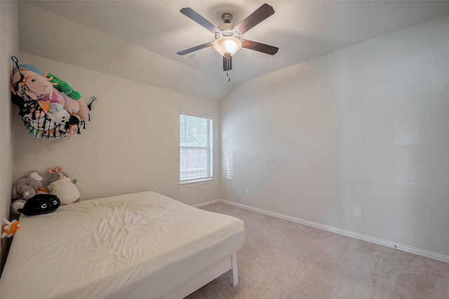 bedroom featuring light carpet, ceiling fan, vaulted ceiling, and baseboards