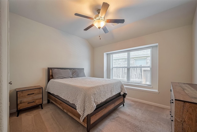 bedroom with a ceiling fan, lofted ceiling, light colored carpet, and baseboards