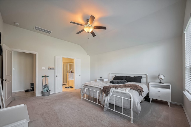 carpeted bedroom featuring visible vents, vaulted ceiling, ceiling fan, ensuite bath, and baseboards