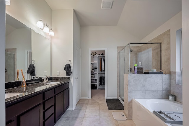 bathroom with lofted ceiling, a stall shower, a sink, and visible vents