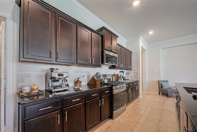 kitchen featuring ornamental molding, stainless steel appliances, tasteful backsplash, and dark stone countertops