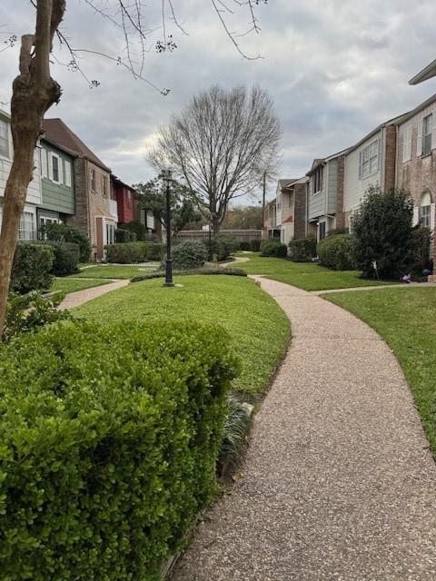 surrounding community featuring a yard and a residential view