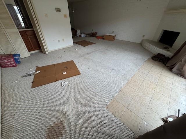 unfurnished living room featuring carpet flooring