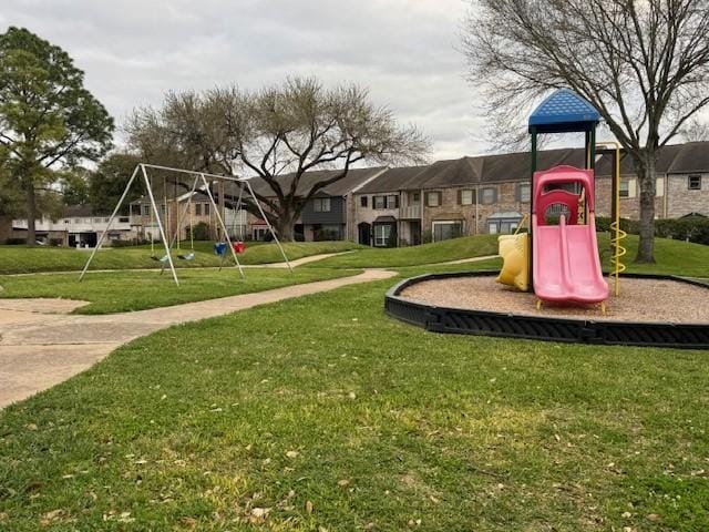 community jungle gym with a yard and a residential view