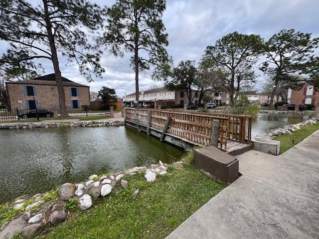 dock area featuring a water view and fence